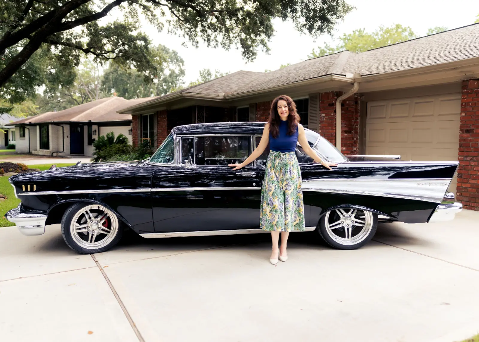 Emily Womack standing beside a vintage black car